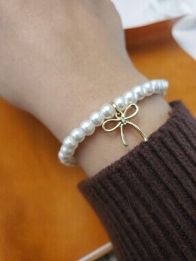 White Pearl Stretch Bracelet with Gold Bow Charm